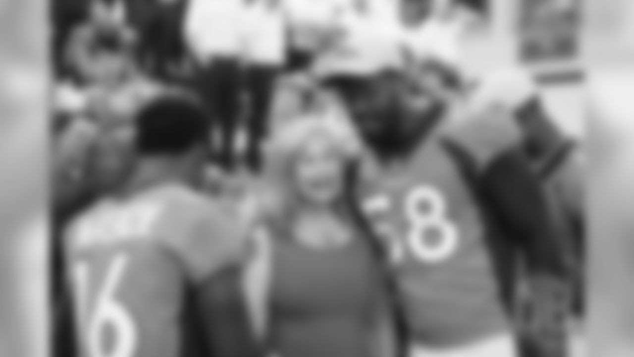 Von Miller greets Annabel Bowlen at team photo day at UCHealth Training Center on September 15, 2018.
