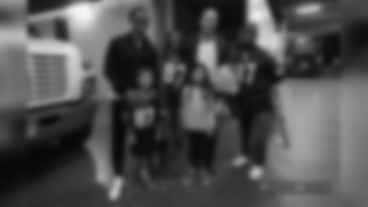 Peyton Manning and his children, Marshall and Mosley, take a photo with Demaryius Thomas and his family after the Broncos' Week 9 game against the Houston Texans at Broncos Stadium at Mile High on November 4, 2018.