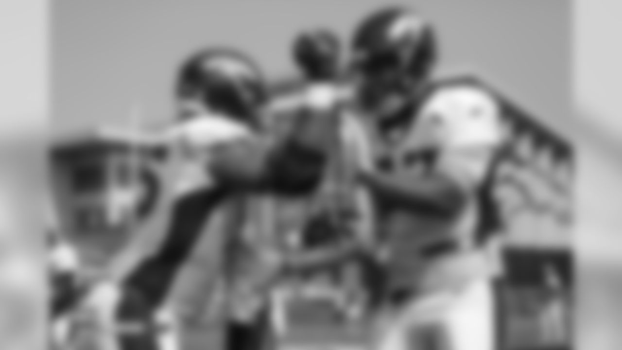 Defensive end Derek Wolfe (95) and defensive end DeMarcus Walker (57) during the ninth day of training camp on August 7, 2018, at UCHealth Training Center.