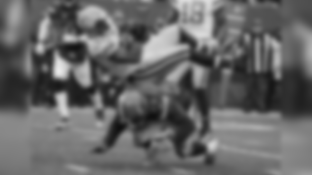 LB Joe Schobert tackles Packers RB Jamaal Williams.