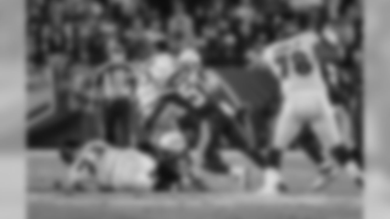 Jatavis Brown tackles Ravens RB Gus Edwards during the Week 16 matchup against the Baltimore Ravens at ROKiT Field at StubHub Center.