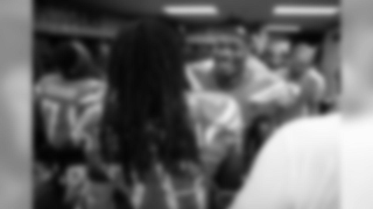 Melvin Gordon and Derwin James celebrate the Bolts 26-10 victory over the Oakland Raiders in the locker room postgame.