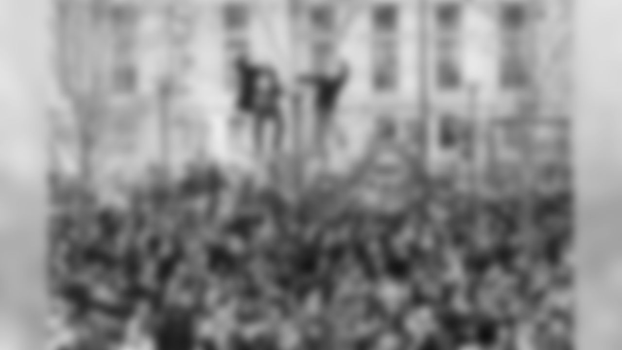 Fans even climbed poles to get a good view of the parade.