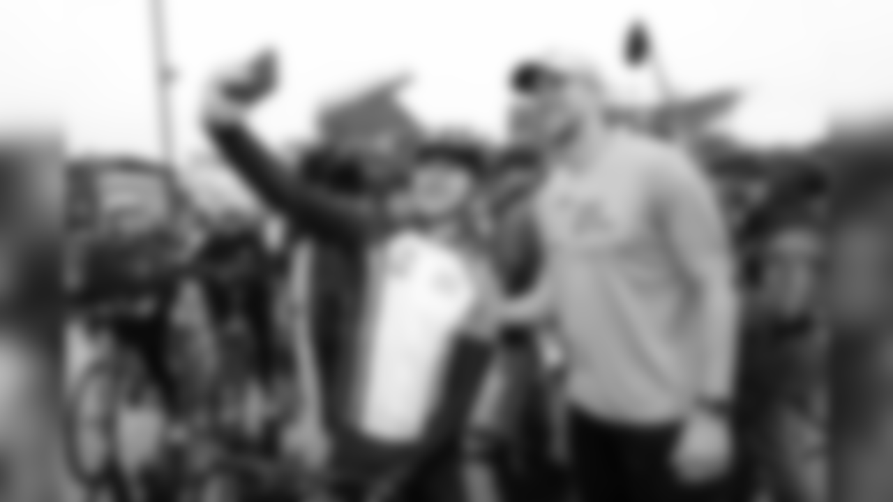A lucky rider takes a picture with Nick Foles