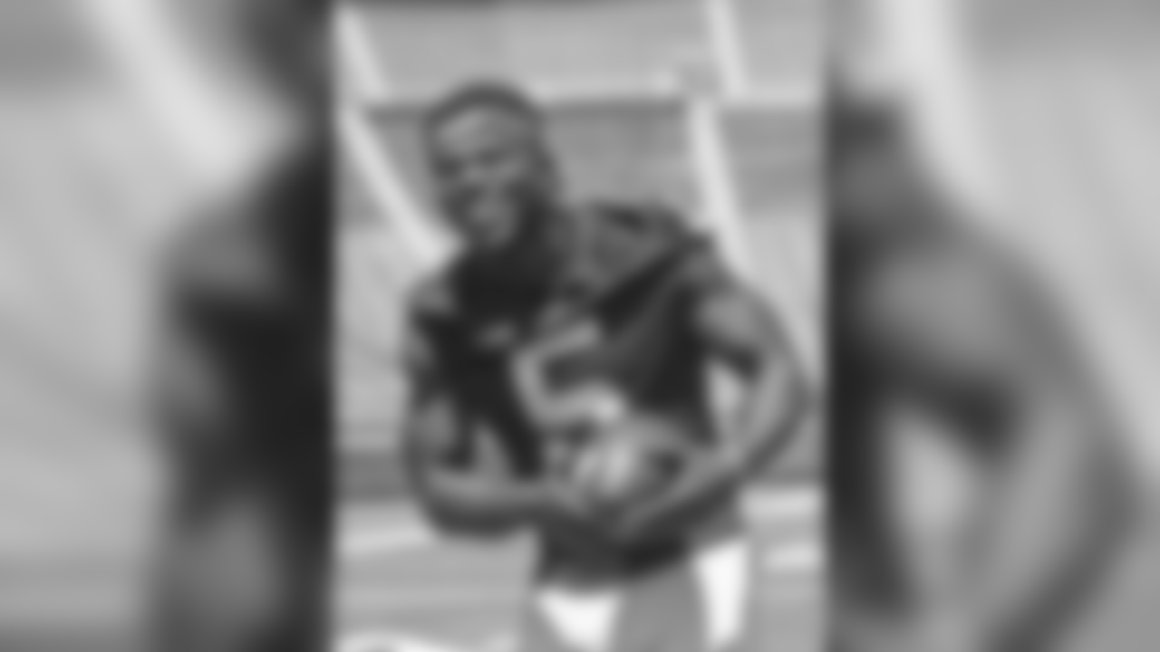 Michigan defensive back Jabrill Peppers laughs as he poses for photographers on the field in Michigan Stadium, during the NCAA college football team's annual media day in Ann Arbor, Mich., Thursday, Aug. 6, 2015. (AP Photo/Tony Ding)
