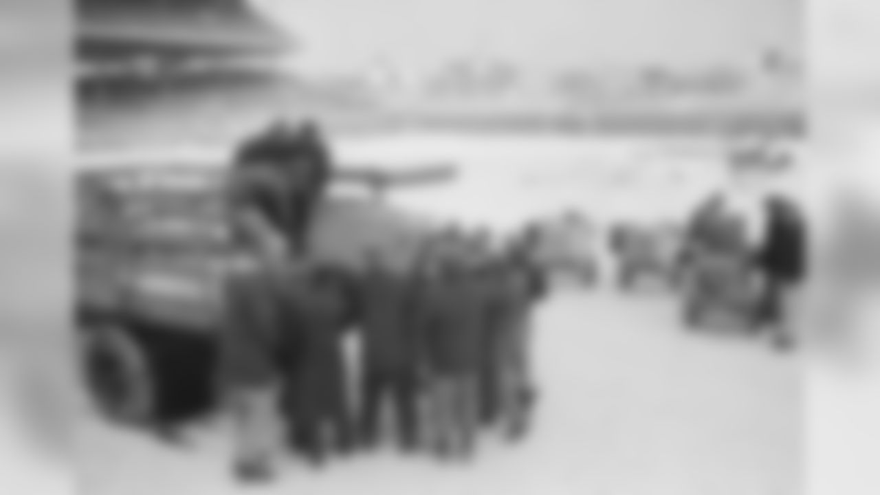 Bleak Wrigley Field, covered with new snow, gets a warm-up crew in Chicago, Dec. 23, 1963. They're unloading devices which provide a hot air flow calculated to soften frozen playing field, now under tarpaulins, upper left. The New York Giants and the Chicago Bears will play for the NFL championship. (AP Photo/Charles Knoblock)