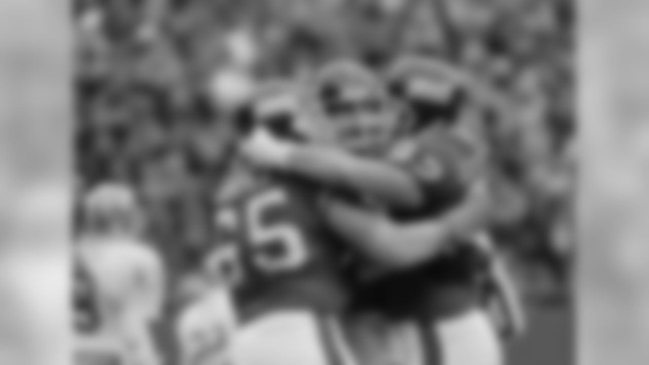 New York Giants player Bart Oates (65), Conrad Goode (62) and an unidentified teammate, hug after the Giants pulled ahead of the San Francisco 49ers during the third quarter, Sunday, Dec. 29, 1985 at Giant Stadium in East Rutherford, N.J. The Giants advanced in the NFL playoffs by beating San Francisco 49ers 17--3 and will play the Chicago Bears Jan. 5th. (AP Photo)