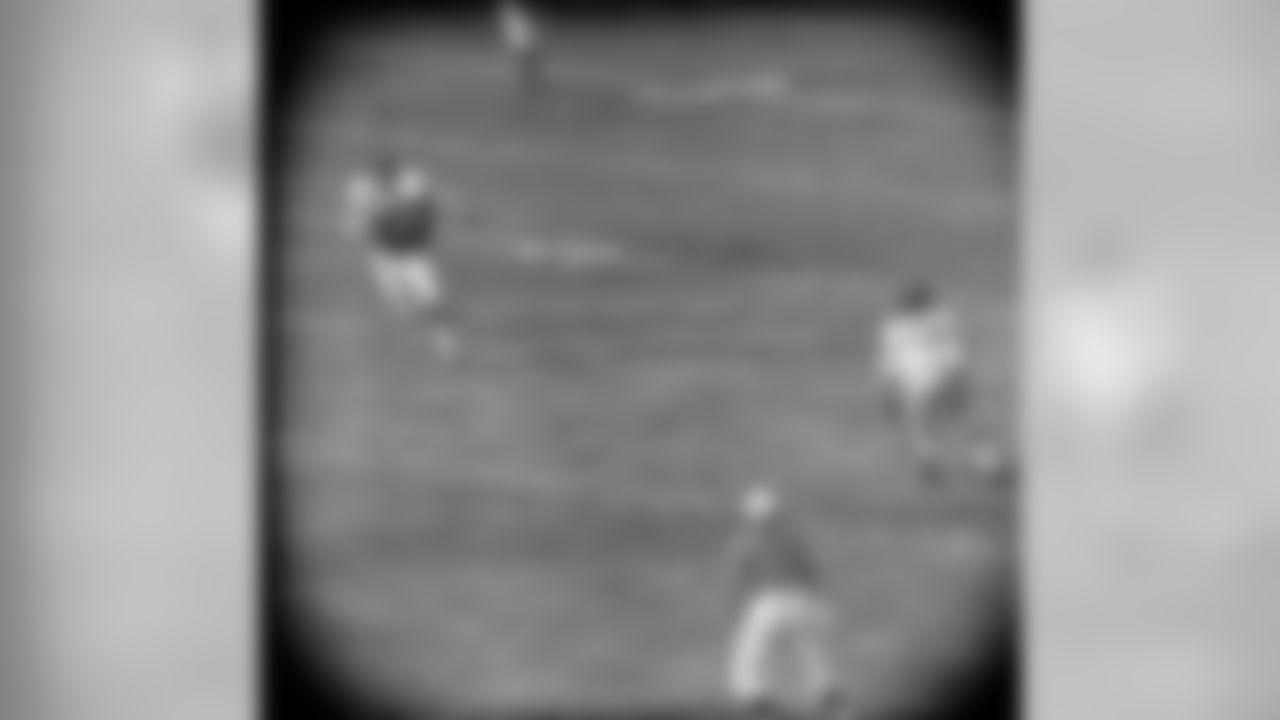 Lennie Moore (24) of the Baltimore Colts catches a pass from Johnny Unitas in behind Linden Crow (41) of the New York Giants during the first quarter of play in New York, Dec. 27, 1959. Dick Nolan (25) of the Giants looks on. The play was good for a total of 60 yards and a touchdown in the first quarter. (AP Photo/Harry Harris)