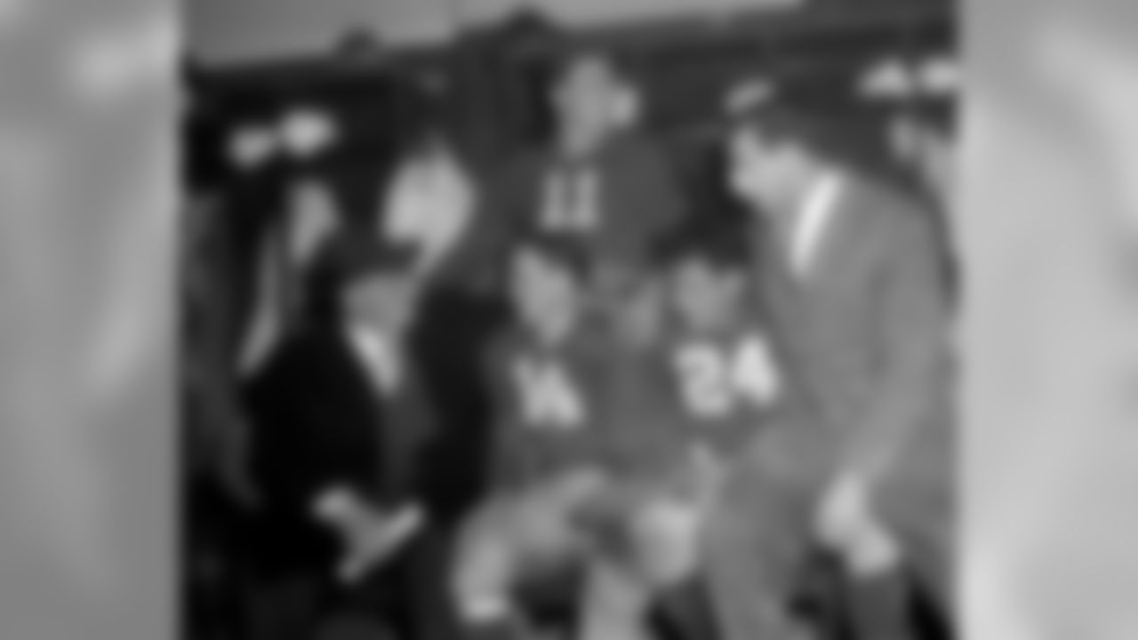 New York Giants coach Steve Owen, left, has a happy word for some of his players in the dressing room after their 31-7 victory over the Washington Redskins in Washington on Dec.12, 1943. The Giants' victory ties them in the Eastern division with the Redskins and a play off next week. From left to right are Owen, Ward Cuff (14), Will Walls (24), Frank Libel and Steve Pritko (11). (AP Photo)
