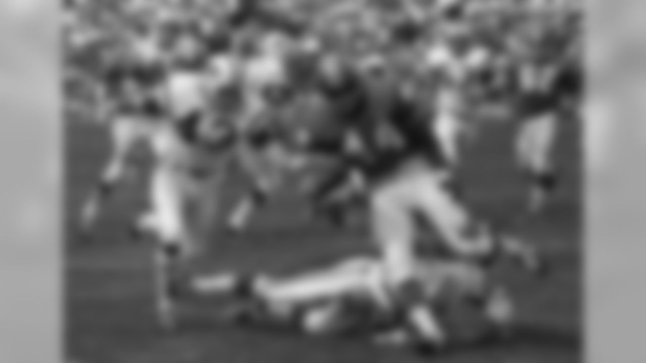 FILE - In this September 1969 file photo, Denver Broncos' Floyd Little avoids the tackle of New York Jets' Steve O'Neal (20) during a football game in Denver. At left is Jets' John Dockery (43). In August 2009, a month after retiring from the car business by shuttering the dealership he'd run for 32 years, Little was finally a Pro Football Hall of Fame nominee, something he had started to suspect he'd never see in his lifetime. (AP Photo/File)