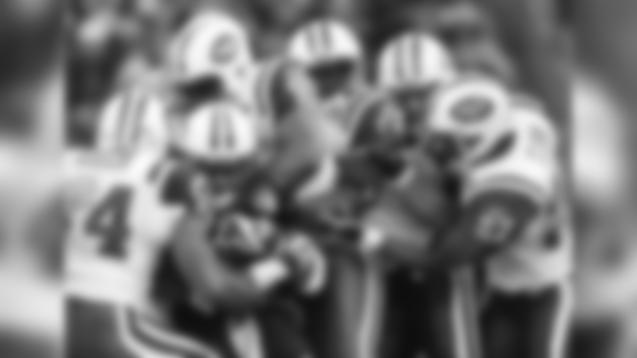 Tennessee Titans running back LenDale White, second from left, is stopped by New York Jets linebacker Victor Hobson (54) and a quartet of teammates in the first quarter of an NFL football game in Nashville, Tenn., Sunday, Dec. 23, 2007. Also in on the stop are Jets' C. J. Mosley (95), David Harris (52), Mike DeVito, second from right, and Abram Elam (27). (AP Photo/Mark Humphrey)