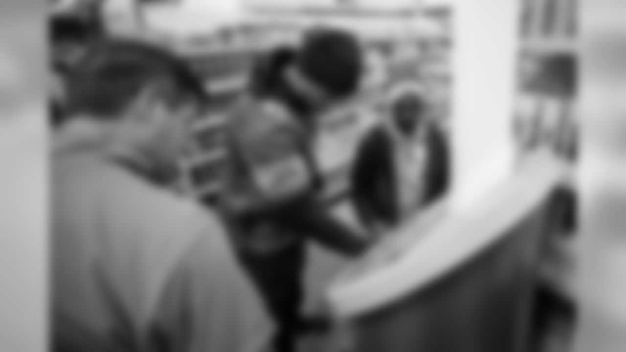Detroit Lions linebacker Devon Kennard (42) with a student from Detroit Lions Academy at Shop with a Lion at Meijer on Tuesday, Dec. 4, 2018 in Detroit.