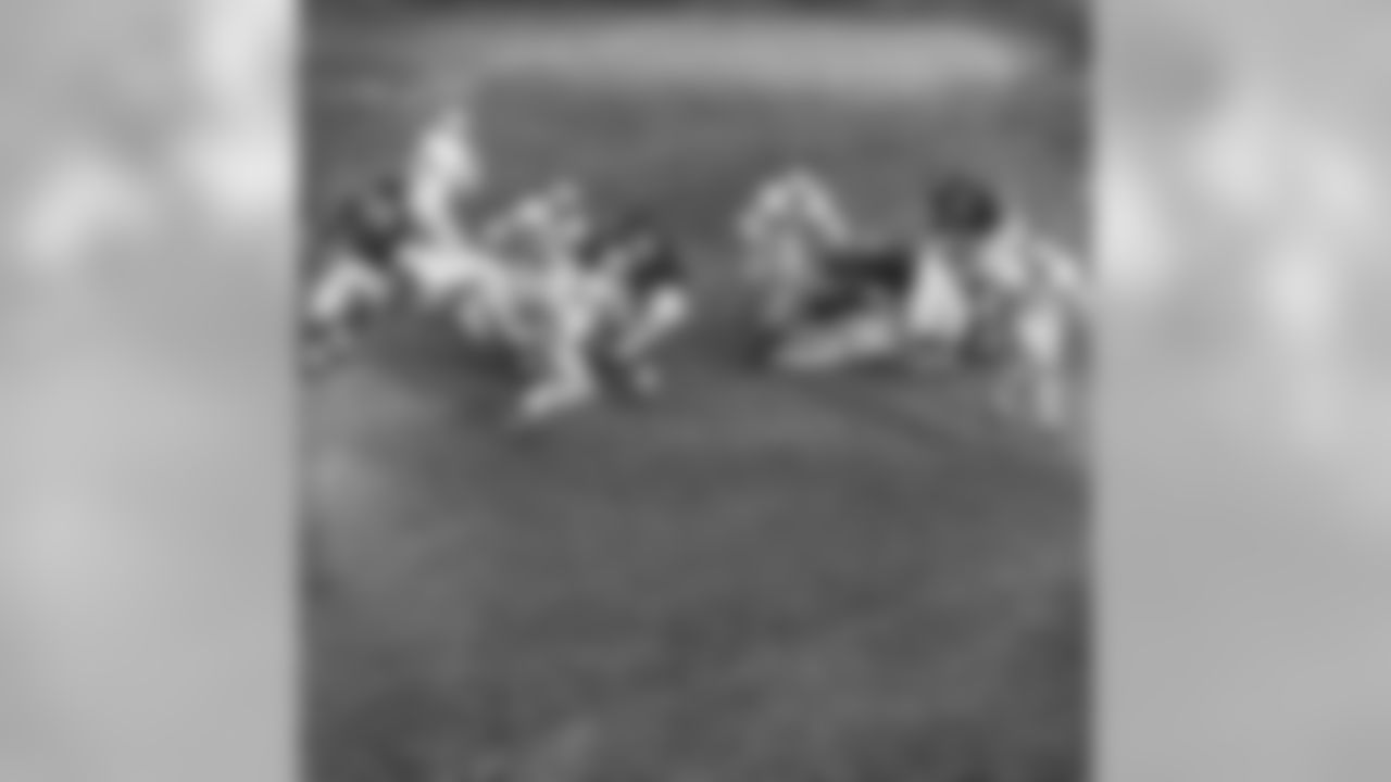 Detroit Lions back Howard Cassady (40) shoots toward the big hole in the Chicago Bears defense in the third quarter, Dec. 14, 1959, Chicago, Ill. The Bears guard Bill George (61) and end Doug Atkins (81) moved over to bring him down. He gained only two yards on the play. The Bears won, 25-14. At left is Lions John Henry Johnson (35) and Jim Gibbons (80). (AP Photo/Ed Maloney)