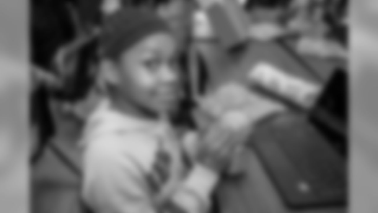 Students at Mary McLeod Bethune Elementary-Middle School open gifts on Tuesday, Dec. 18, 2018 in Detroit.