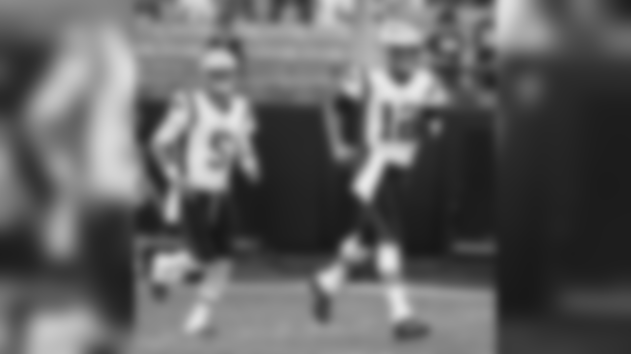 New England Patriots' Tom Brady (12) and Danny Etling (5) takes the field before a preseason NFL football game against the Carolina Panthers in Charlotte, N.C., Friday, Aug. 24, 2018. (AP Photo/Jason E. Miczek)