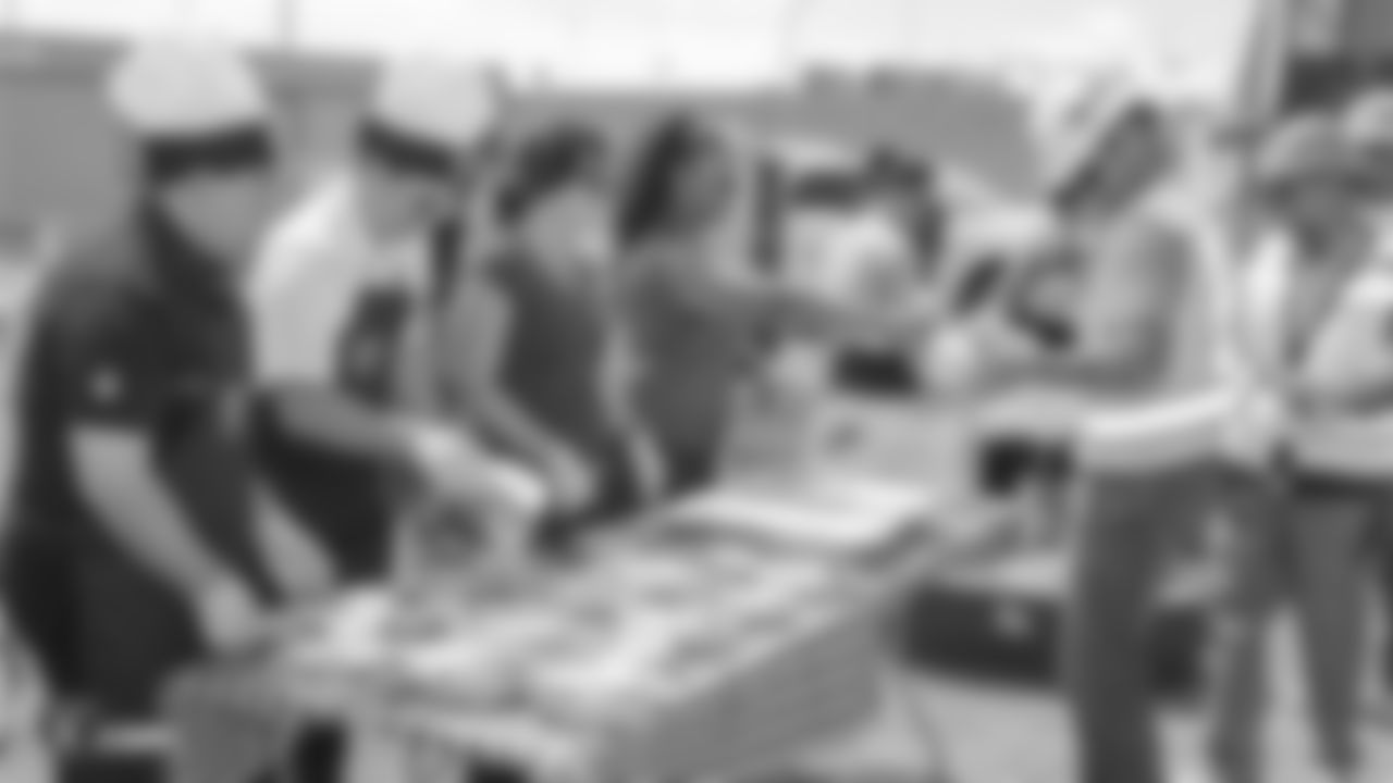 Staff members from The Oakland Raiders front office spend the day with construction workers of the Las Vegas Stadium worksite by handing out lunches and sharing a meal, Wednesday, June 28, 2018, at the Las Vegas Stadium worksite in Las Vegas, Nevada.