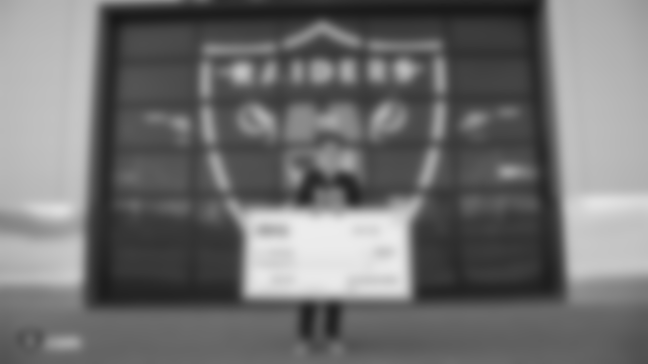 The Raiders, represented by alumnus Sam Williams, surprise Gabriel Reuter, a Bay Area high school student who will be attending UCSD in the fall, with a $5,000 scholarship for his strong work ethic and community outreach, at the Oakland Raiders Practice Facility, Friday, March 15, 2019, in Alameda, Calif.