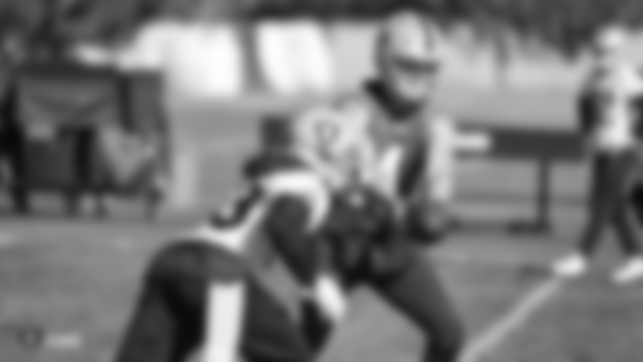 Oakland Raiders running back DeAndré Washington (33) and quarterback Derek Carr (4) on the field for practice at the Oakland Raiders Practice Facility, Thursday, November 22, 2018, in Alameda, California.