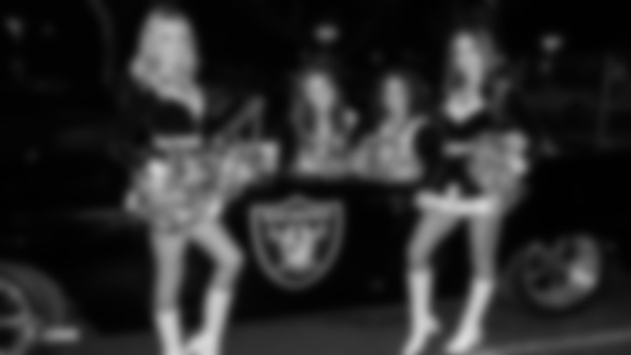 The Raiderettes are featured in the annual Holidays/Santa's Arrival Parade as they proceed in convertible cars through Town Square, Friday, November 16, 2018, in Las Vegas, Nev.