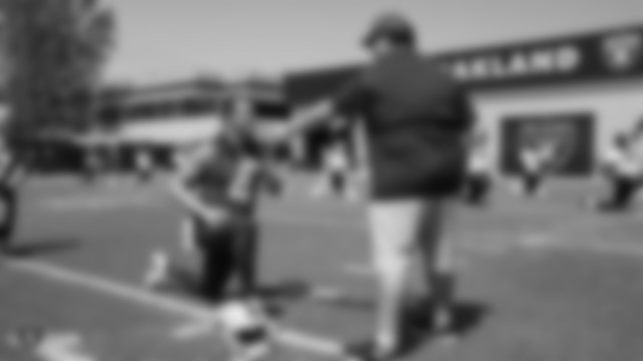 Raiders quarterback Derek Carr (4) and defensive coordinator Paul Guenther at an Organized Team Activity (OTA) at the Raiders Practice Facility in Alameda, Calif.