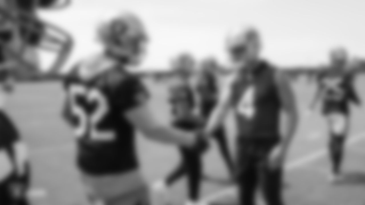 Raiders linebacker Marquel Lee (52) and quarterback Derek Carr (4) at an Organized Team Activity (OTA) at the Raiders Practice Facility in Alameda, Calif.