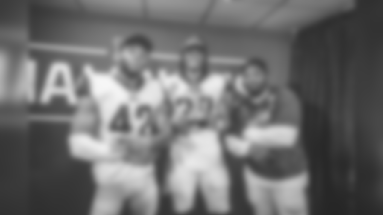 Running back (30) Todd Gurley of the Los Angeles Rams holds the George Halas Trophy in the locker room with (35) CJ Anderson and (42) John Kelly after the Rams 26-23 victory over the Saints in the NFC Championship Game, Sunday, January 20, 2019, in New Orleans, LA. (Jeff Lewis/Rams)