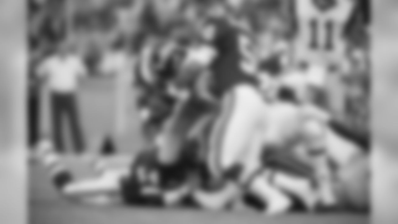 Running back Curt Warner (c) from the L.A. Rams tries to break through defense of the Kansas City Chiefs during the American Football Game L.A. Rams Vs Kansas City Chiefs in West Berlin?s Olympic Stadium on Saturday, August 11, 1990. (AP Photo/Peter Anfrews)