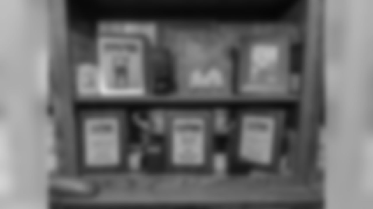 A bookcase in the living room is filled with more plaques and photos of both Tom sons. New Orleans Saints OL Cameron Tom grew up in Baton Rouge, La.