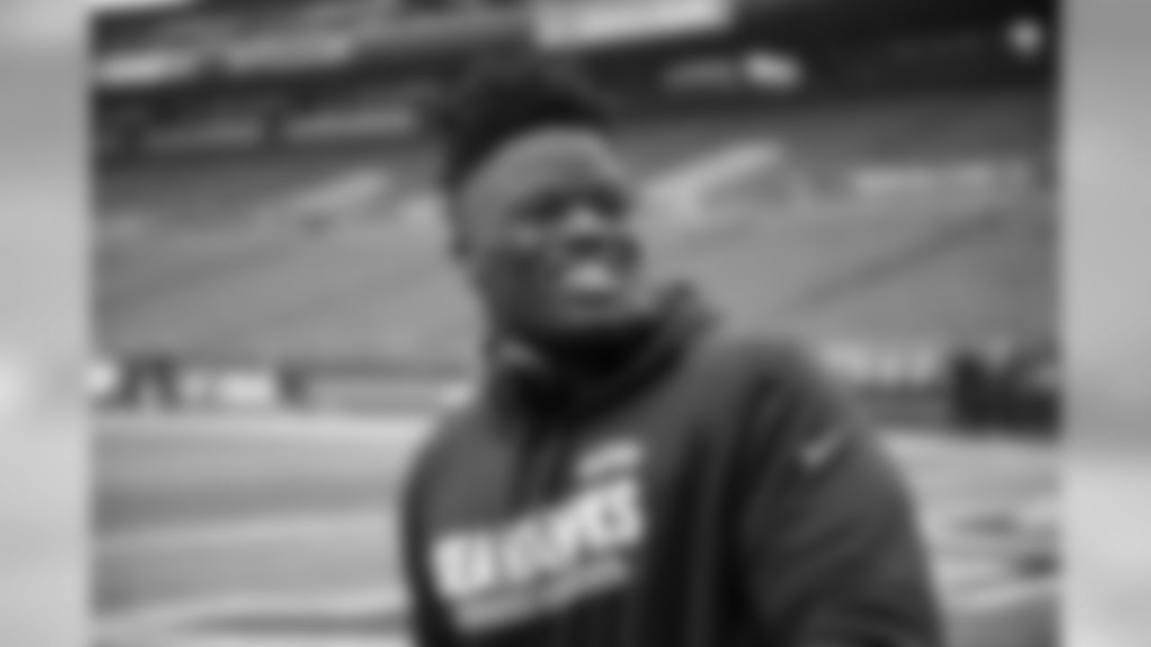 Seahawks offensive tackle Germain Ifedi smiles on the field during early pregame.
