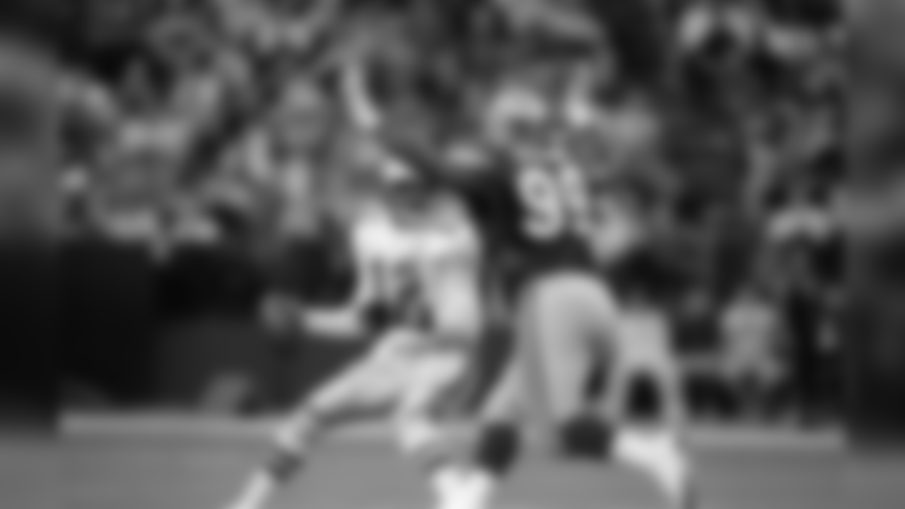 Quarterback Randell Cunningham (12) of the Philadelphia Eagles is unable to avoid the rush of Cortez Kennedy (99) of the Seattle Seahawks during the fourth quarter of NFL game in Seattle, Dec. 13, 1992. (AP Photo/Bill Chan)