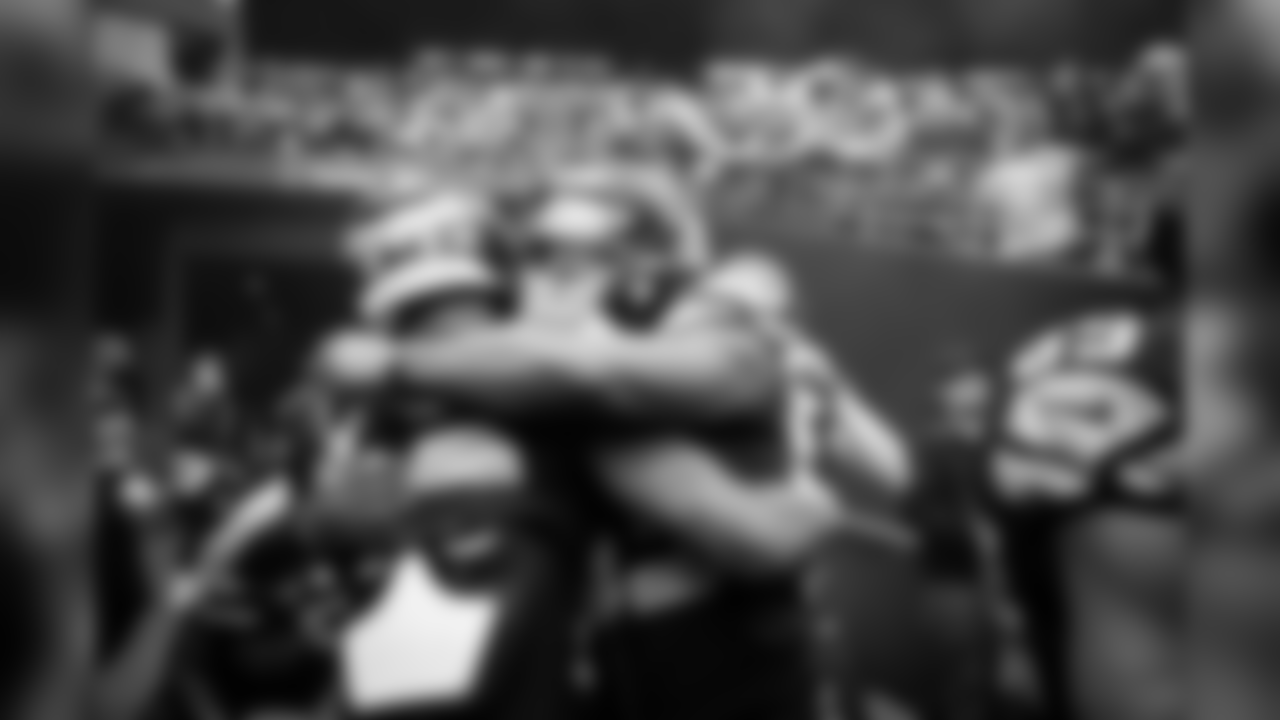 Teammates Chris Carson and David Moore hug before the team is introduced to the crowd at CenturyLink Field.