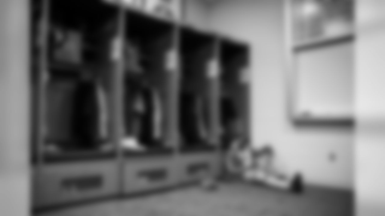 Receiver David Moore sits on the floor near his corner locker in the Seahawks locker room at CenturyLink Field.