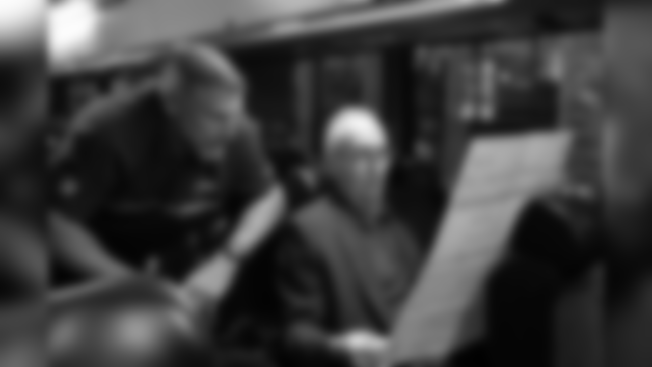 On the staff bus, Seahawks radio play-by-play announcer Steve Raible does game preparation with analyst and former Seahawks linebacker Dave Wyman.