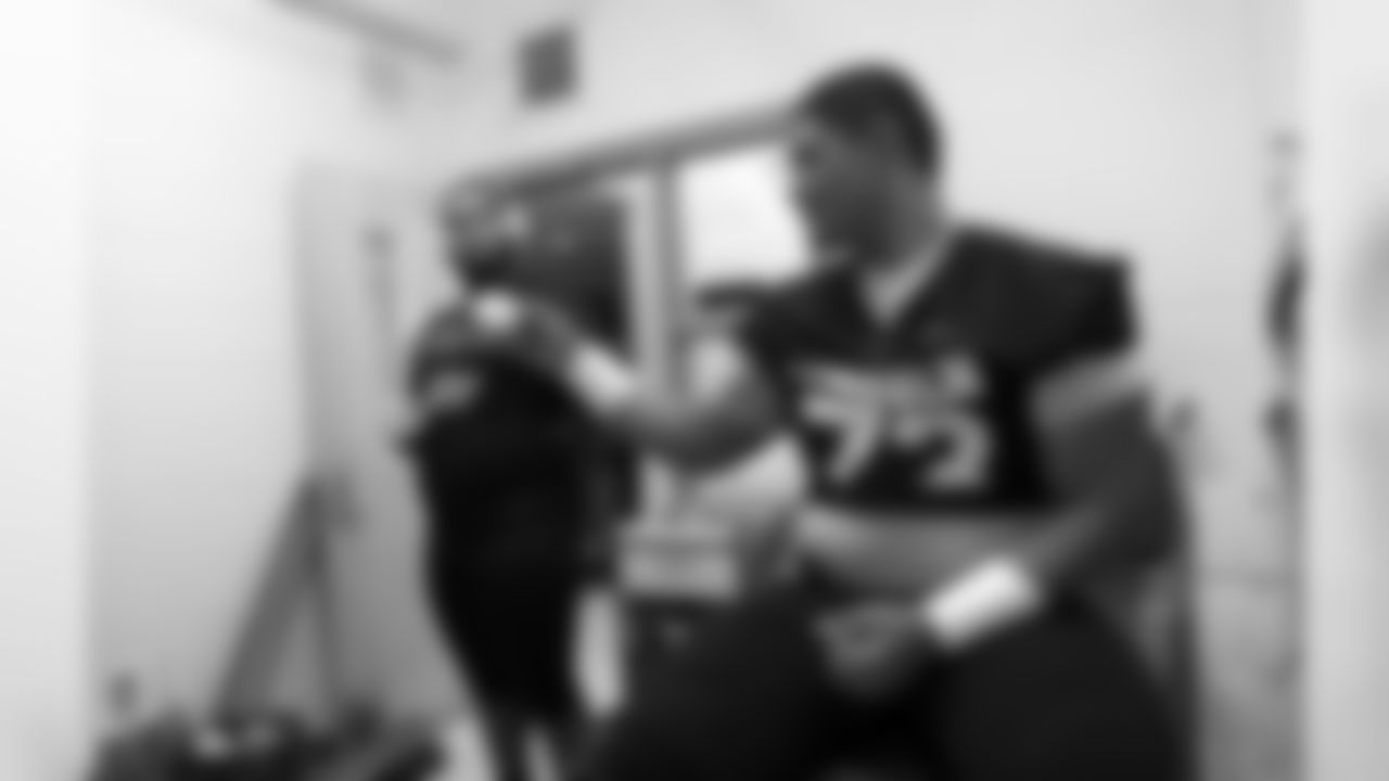 LINCOLN JUNIOR LINEMAN CALEB PUAPUAAGA (73) SHARES A FIST BUMP PRIOR TO THE LINCOLN - RAINIER BEACH 3A STATE FOOTBALL PLAYOFF GAME AT LINCOLN BOWL.