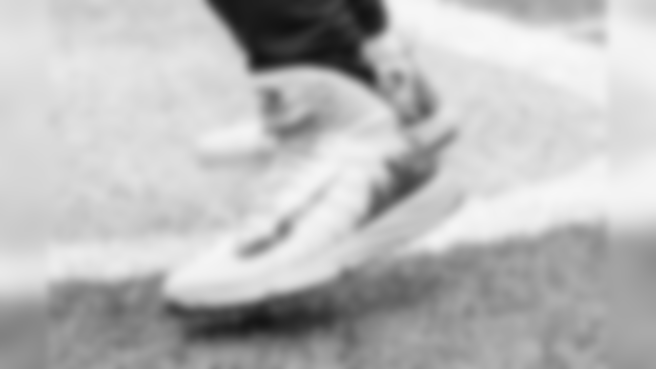 Russell Wilson's custom Nike cleats feature his logo and the Seattle city skyline.