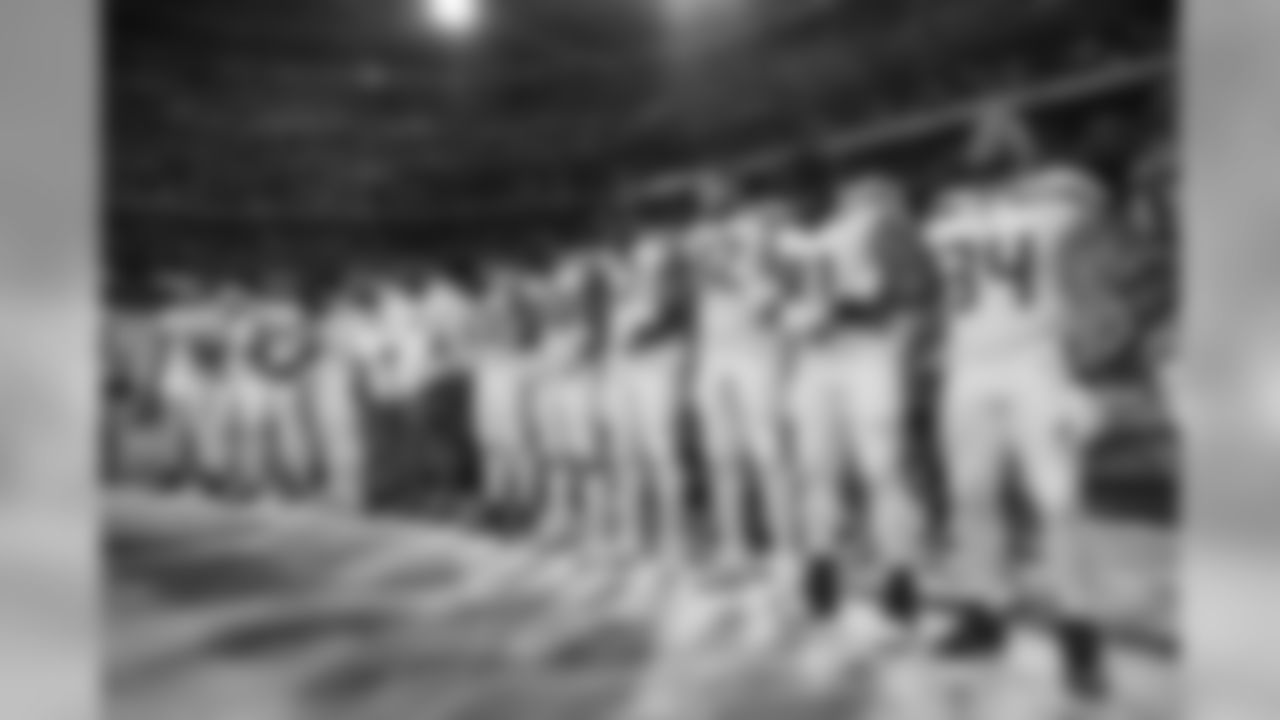 The Seahawks stand at attention, arms linked, for the playing of the national anthem.