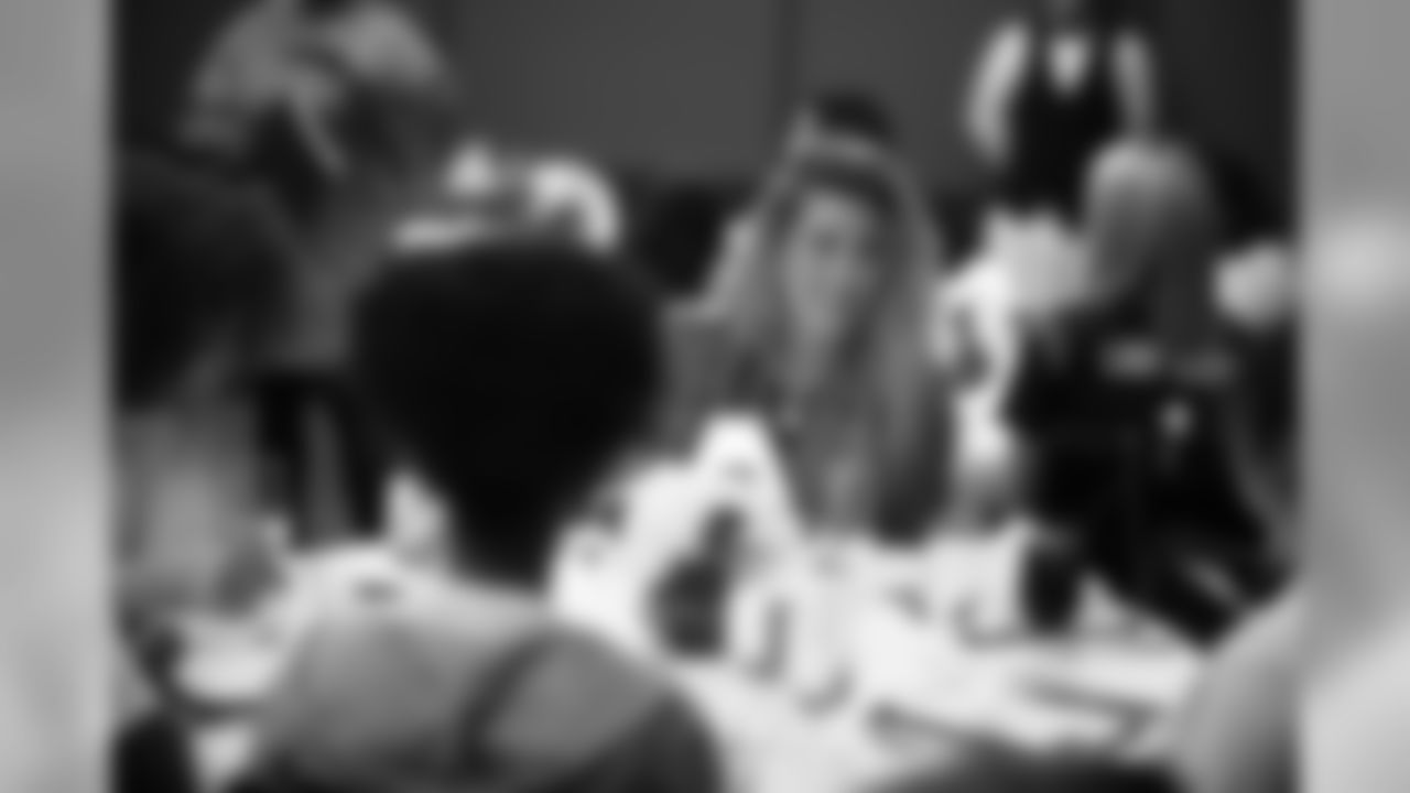 An image from the Oct. 18, 2018 community development event in which the Lady Texans learned about dinner ettiequte with Houston-area students.