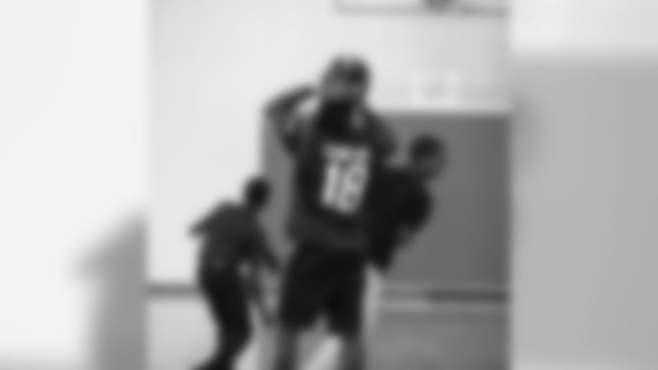 An image from the Sept. 25, 2018 community development event in which Sammie Coates Jr. and Julien Davenport played basketball and ate pizza with local students.