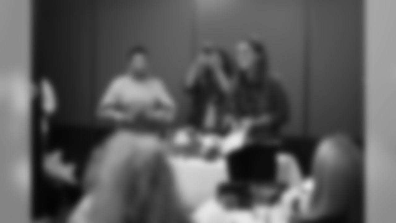 An image from the Oct. 18, 2018 community development event in which the Lady Texans learned about dinner ettiequte with Houston-area students.
