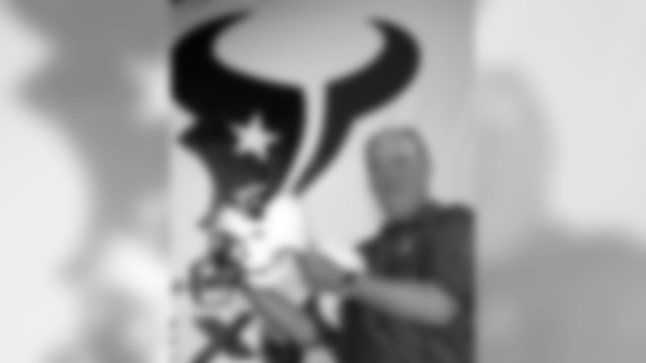 Houston Texans owner Bob McNair poses with the new team's logo and helmet during a rally Wednesday, Sept. 6, 2000, in Houston. The Texans will compete in the 2002 NFL season. (AP Photo/Pat Sullivan)