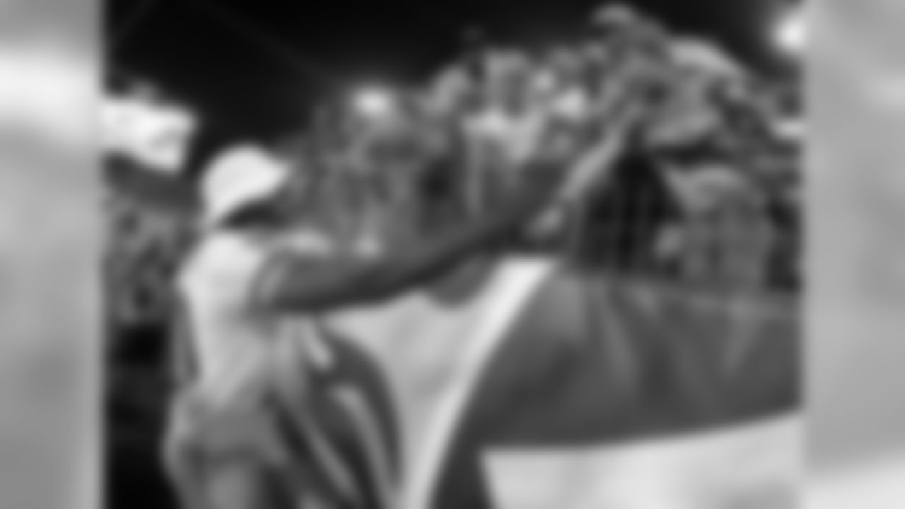 Washington Redskins quarterback Robert Griffin III shakes hands with fans following a 22-21 win over the Tennessee Titans in a preseason NFL football game on Thursday, Aug. 8, 2013, in Nashville, Tenn. (AP Photo/Wade Payne)