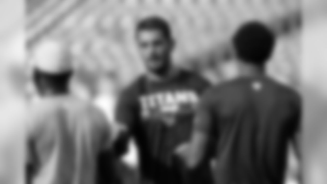 Tennessee Titans quarterback Marcus Mariota, center, greets teammates before a preseason NFL football game against the Tampa Bay Buccaneers Saturday, Aug. 18, 2018, in Nashville, Tenn. (AP Photo/Mark Zaleski