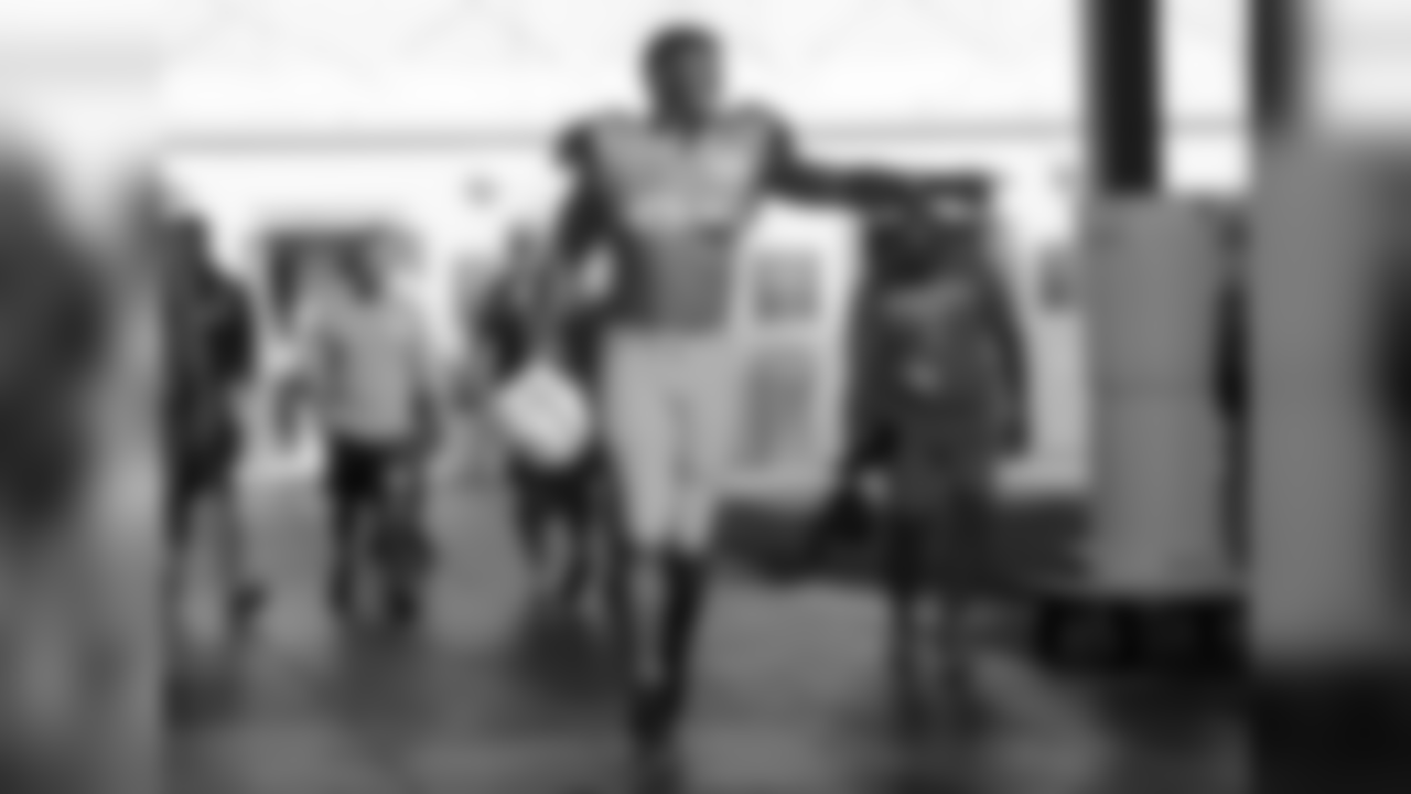 Miami Dolphins defensive end Cameron Wake walks onto the field at the NFL football team's training camp, Monday, July 30, 2018, in Davie, Fla. (AP Photo/Lynne Sladky)