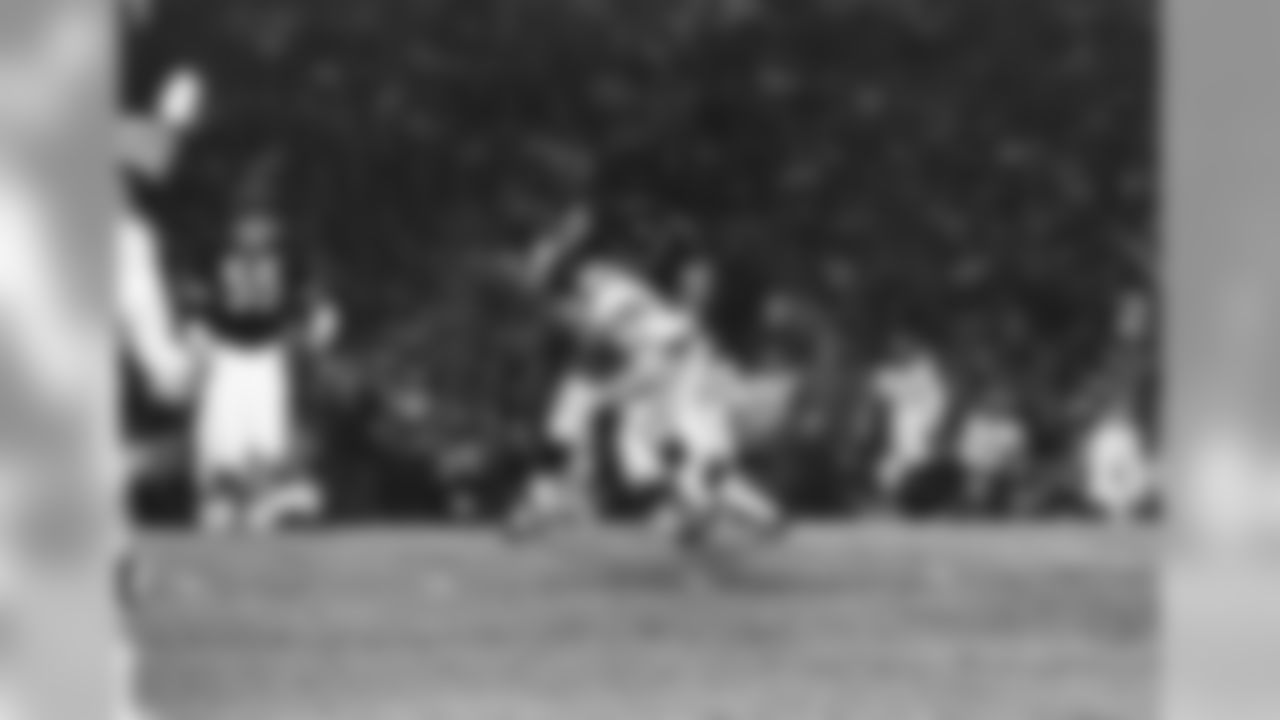 Minnesota running back Bill Brown drives for a first down after taking a pass from quarterback Gary Cuozzo. Chicago Bears' linebacker Ross Brupbacher (31) makes the tackle in the first quarter of the Armed Forces Benefit game in Chicago, Friday, Sept. 11, 1970. (AP Photo/Fred Jewell)