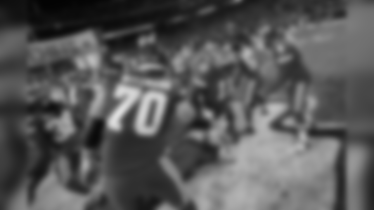 Kansas City Chiefs quarterback Alex Smith (11) is greeted by offensive tackle Bryan Witzmann (70) and quarterback Nick Foles (4) as he runs through a line of team mates in player introductions during a week 14 NFL football game against the Oakland Raiders, Thursday, Dec. 8, 2016, in Kansas City, Mo. The Chiefs won 21-13. (Scott Boehm via AP)