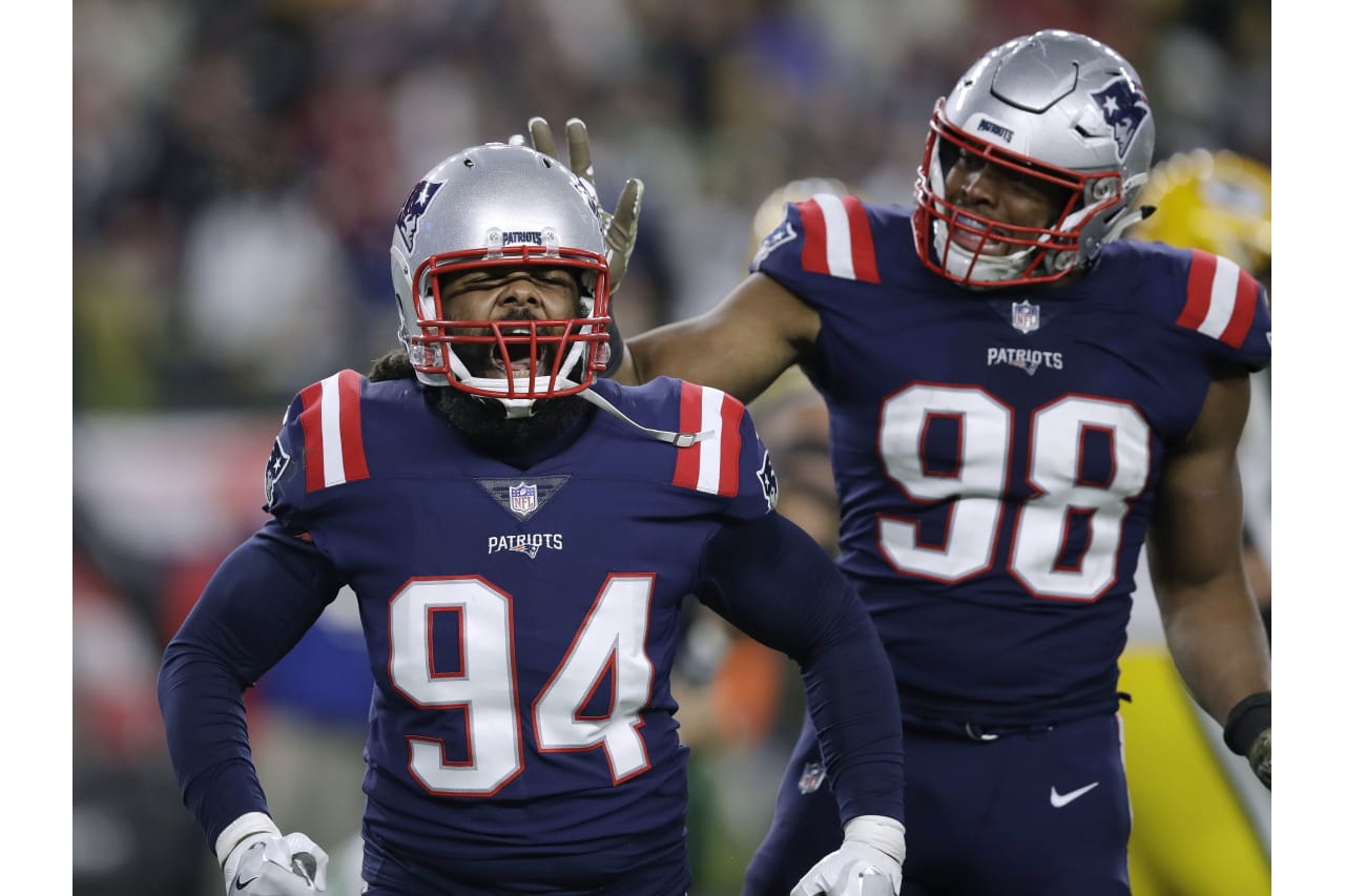 New England Patriots defensive ends Adrian Clayborn (94) and Trey Flowers (98) celebrate their sack of Green Bay Packers quarterback Aaron Rodgers during the second half of an NFL football game, Sunday, Nov. 4, 2018, in Foxborough, Mass. (AP Photo/Charles Krupa)