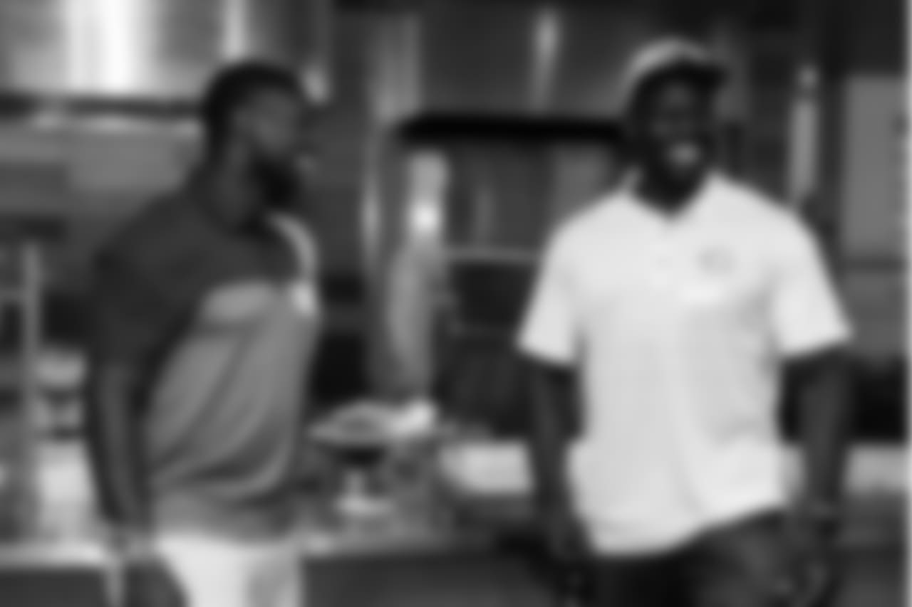 LB Roquan Smith laughs with former Bears player Alex Brown.