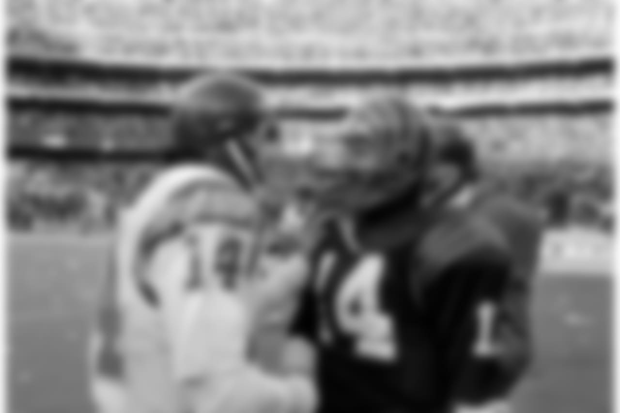 Cincinnati Bengals quarterback Ken Anderson, left, reacts as San Diego Chargers quarterback Dan Fouts, right, looks dejected after the Bengals defeated the Chargers in the AFC championship in Cincinnati on Jan. 10, 1982. Fouts was intercepted twice in the game, and Anderson passed for two touchdowns and no interceptions. (AP Photo)