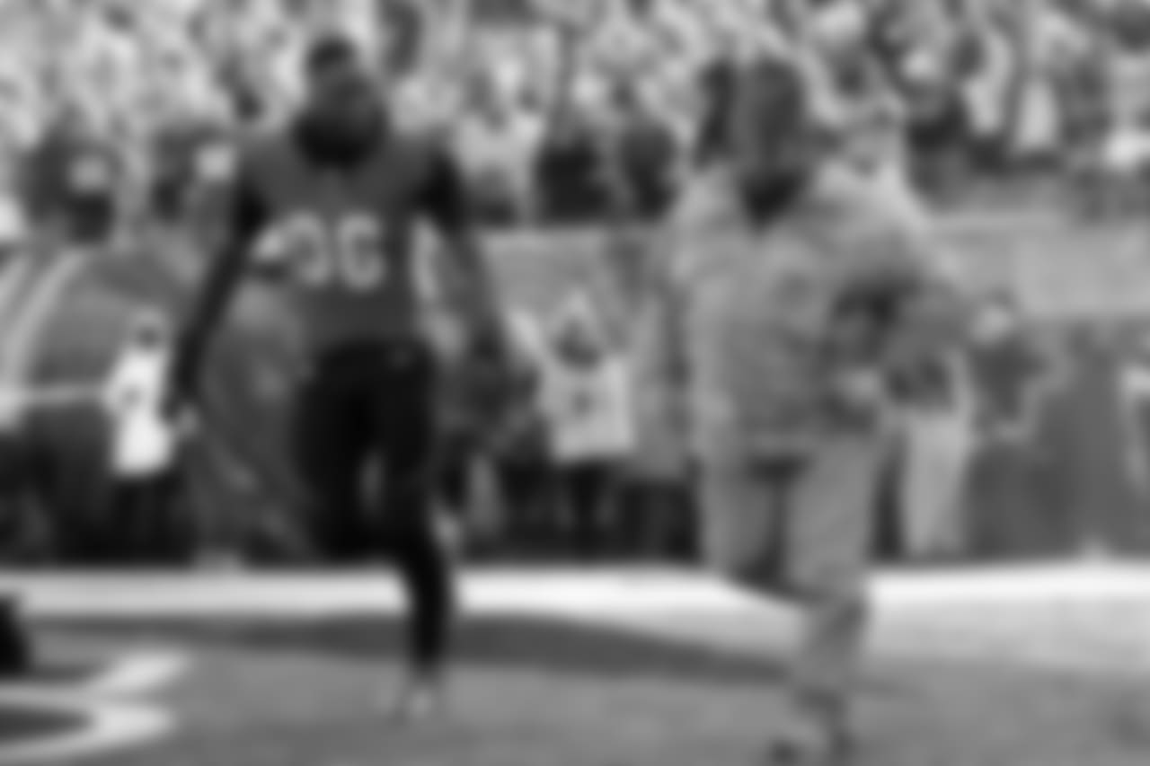 Cincinnati Bengals defensive end Carlos Dunlap (96) takes the field with a member of the armed forces before an NFL football game against the New Orleans Saints, Sunday, Nov. 11, 2018, in Cincinnati. (AP Photo/Frank Victores)