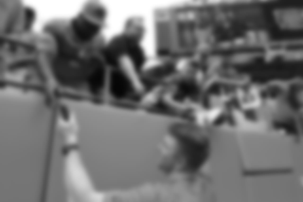 Cincinnati Bengals' Andy Dalton signs autographs for fans before an NFL football game against the Carolina Panthers in Charlotte, N.C., Sunday, Sept. 23, 2018. (AP Photo/Jason E. Miczek)
